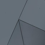 Abstract geometric facade with grey panels and sharp lines in London, Ontario.